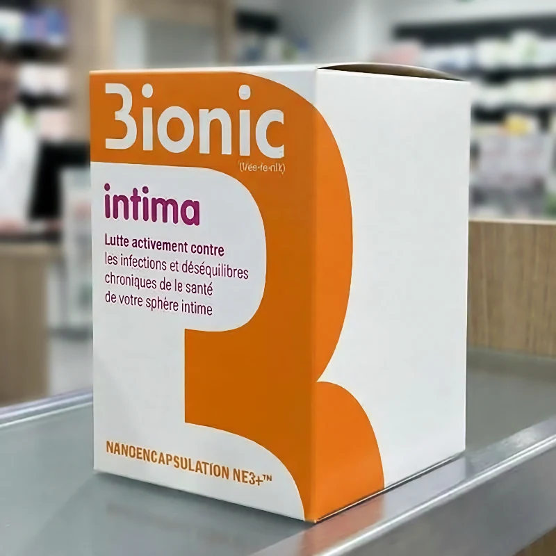 Boîte d'emballage orange et blanche 3ionic Intima posée sur un comptoir de pharmacie